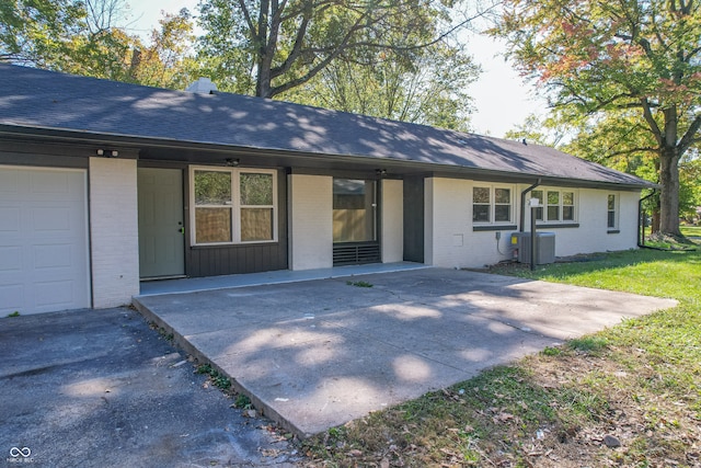 back of house featuring a garage