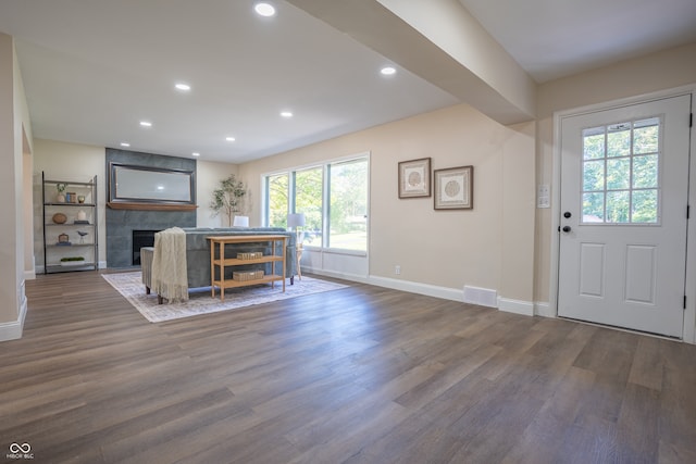 entrance foyer featuring a fireplace and hardwood / wood-style flooring