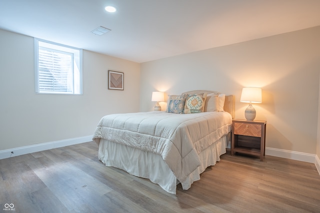 bedroom with hardwood / wood-style flooring