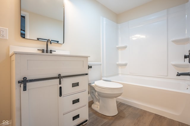 full bathroom featuring vanity, hardwood / wood-style floors, shower / tub combination, and toilet