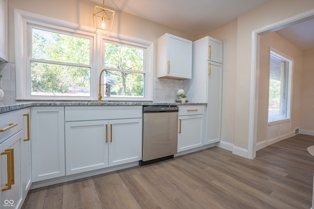 kitchen with tasteful backsplash, light stone countertops, dishwasher, light wood-type flooring, and white cabinets