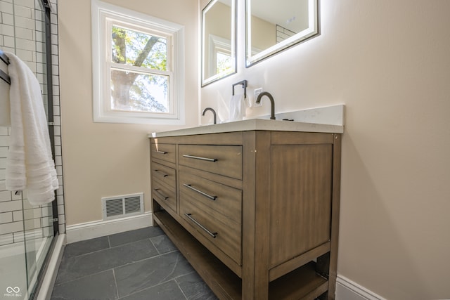 bathroom with vanity, an enclosed shower, and tile patterned floors