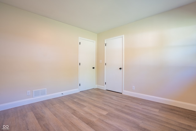 unfurnished room with light hardwood / wood-style flooring