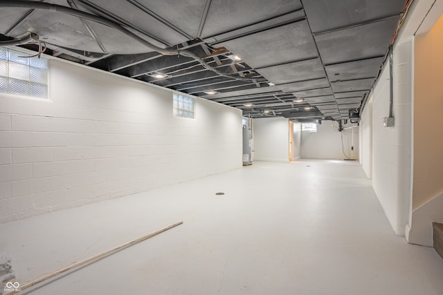 basement with a wealth of natural light and water heater