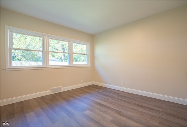 unfurnished room with hardwood / wood-style floors