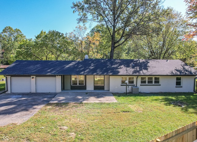 ranch-style house featuring a front yard and a garage