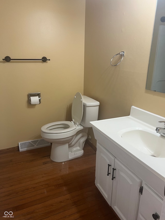 bathroom with vanity, hardwood / wood-style floors, and toilet