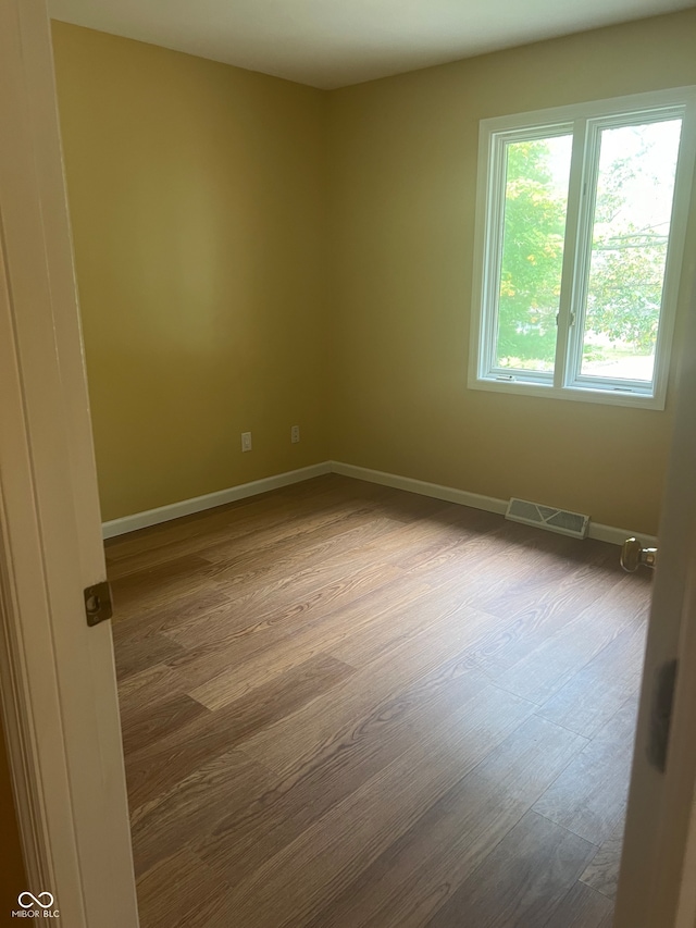 empty room featuring hardwood / wood-style flooring