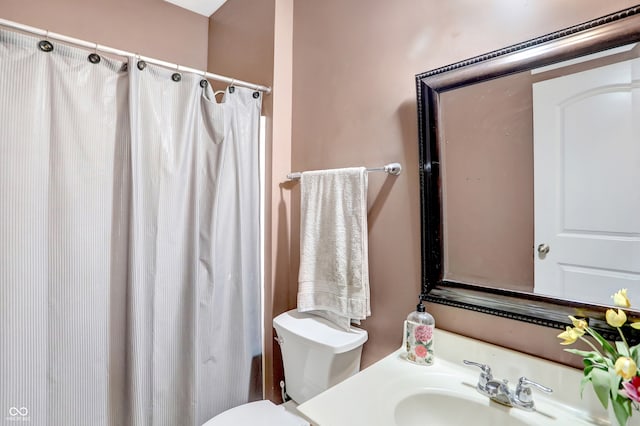 bathroom with vanity, toilet, and walk in shower