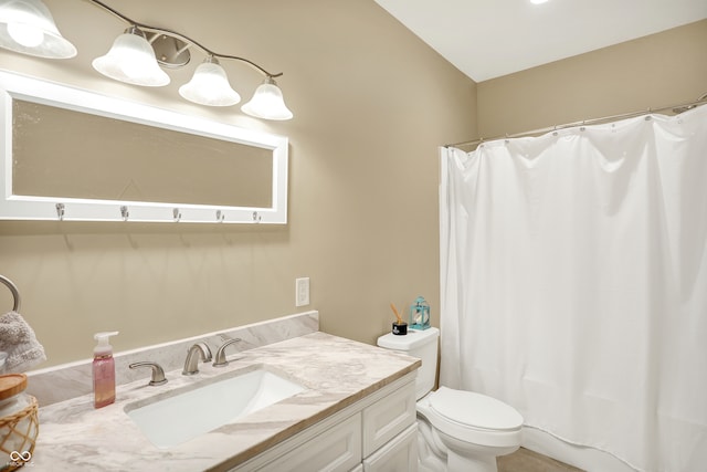 bathroom with vanity, toilet, and walk in shower