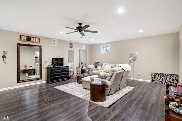 living room featuring ceiling fan and dark hardwood / wood-style flooring