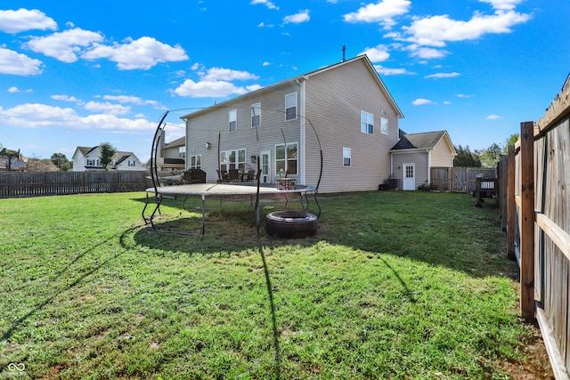 rear view of house featuring a patio area and a lawn