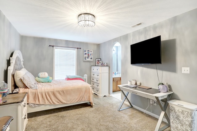 carpeted bedroom with a notable chandelier