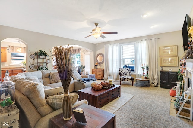 carpeted living room with ceiling fan and sink