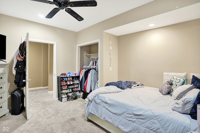 bedroom with light colored carpet, a closet, and ceiling fan