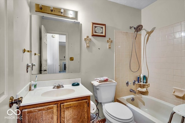 full bathroom featuring toilet, tiled shower / bath combo, and vanity