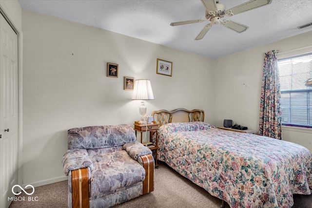 bedroom featuring light colored carpet, a closet, and ceiling fan