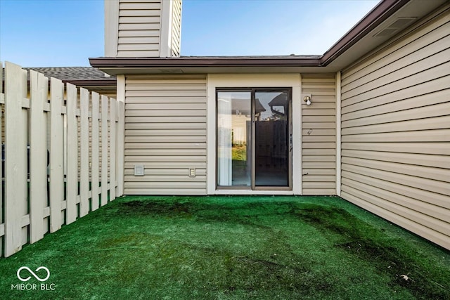 entrance to property with a yard