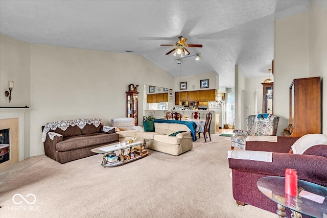 carpeted living room with lofted ceiling, a textured ceiling, and ceiling fan