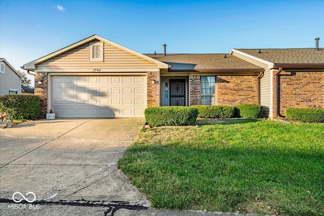 single story home featuring a garage and a front lawn