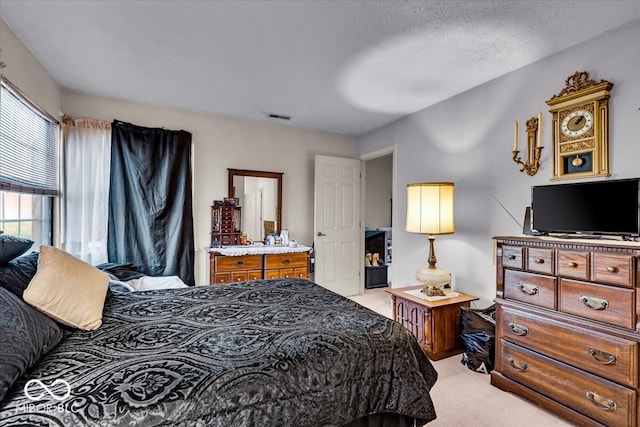 carpeted bedroom featuring a textured ceiling