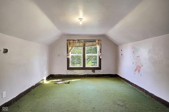 bonus room featuring vaulted ceiling and carpet