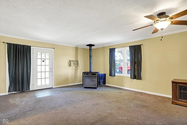 unfurnished living room with carpet floors, a textured ceiling, ornamental molding, and ceiling fan