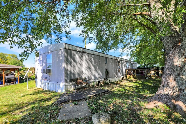 view of property exterior featuring cooling unit and a lawn