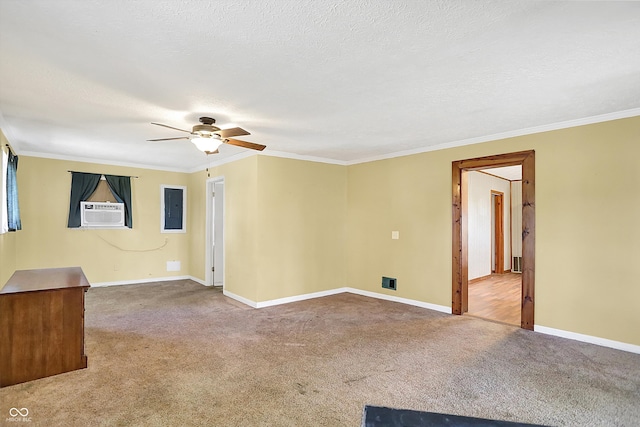 carpeted empty room with ceiling fan, electric panel, ornamental molding, cooling unit, and a textured ceiling