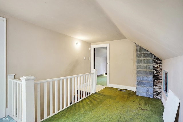 bonus room with lofted ceiling and carpet flooring