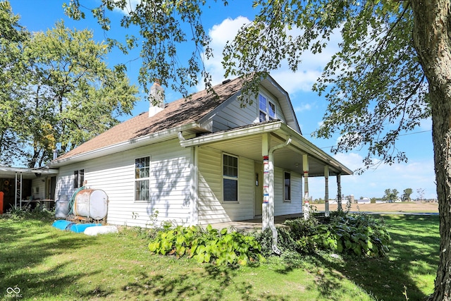 rear view of property featuring a yard