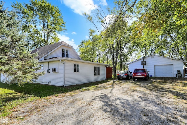 view of property exterior featuring an outbuilding and a garage