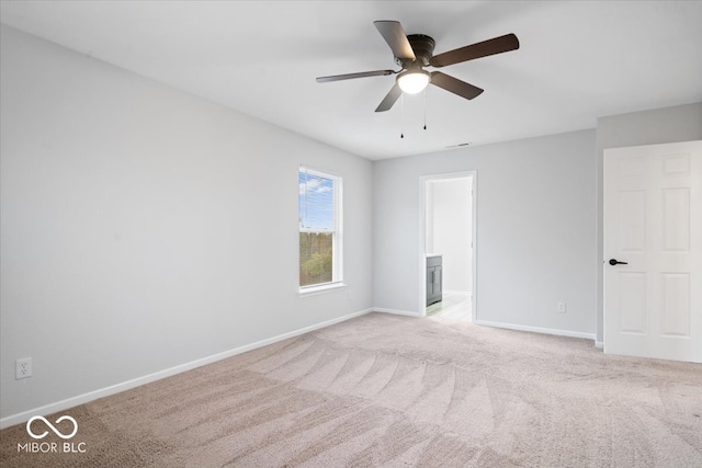 carpeted empty room featuring ceiling fan