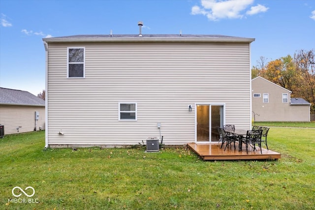 rear view of property featuring a yard, a deck, and cooling unit