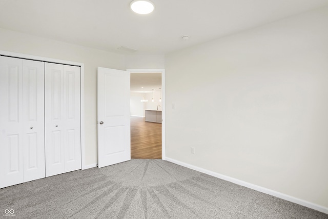 unfurnished bedroom with carpet and a closet