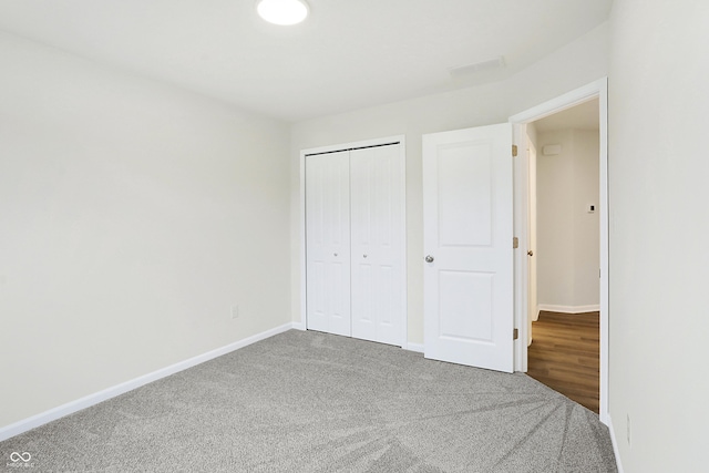 unfurnished bedroom with carpet flooring and a closet