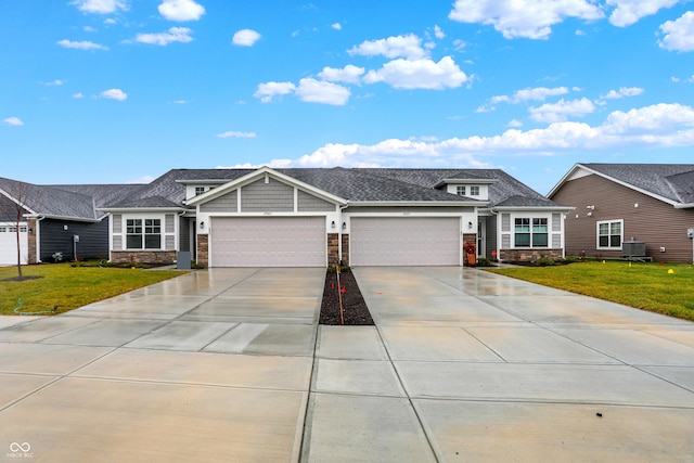 ranch-style house featuring central AC, a front yard, and a garage