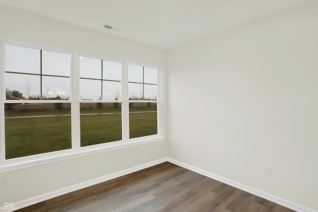 unfurnished room with hardwood / wood-style floors