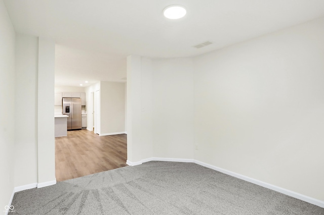 unfurnished room with light wood-type flooring