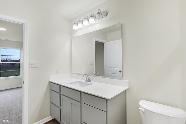 bathroom featuring vanity and toilet