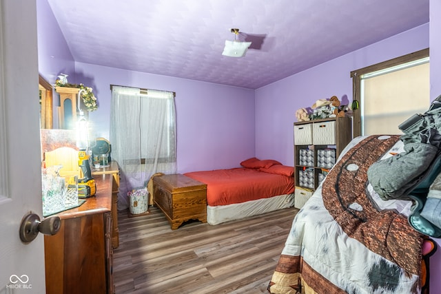 bedroom with dark hardwood / wood-style flooring