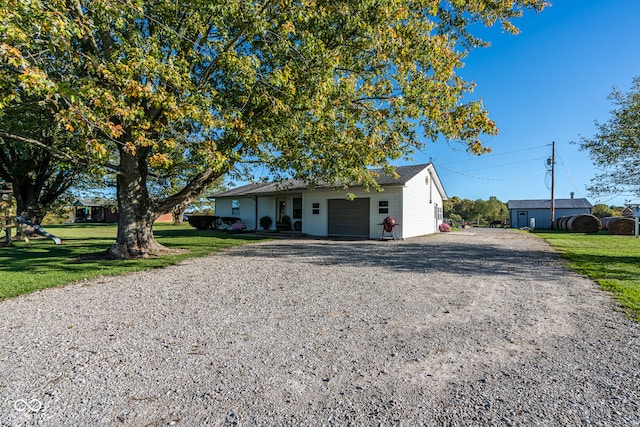 ranch-style house with a garage and a front yard