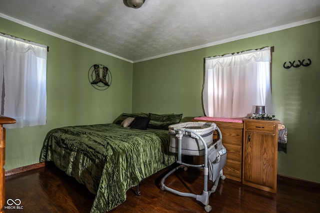 bedroom with a textured ceiling, crown molding, and dark hardwood / wood-style flooring