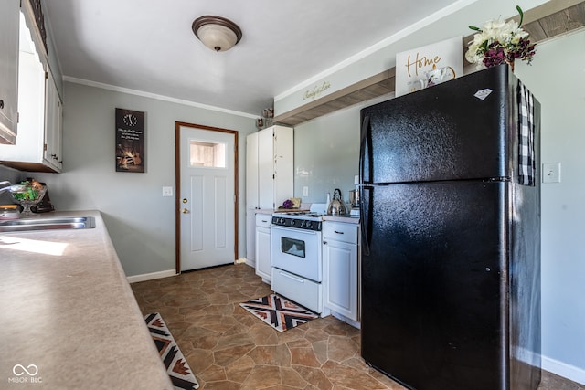 kitchen with black fridge, sink, white cabinets, and white range oven