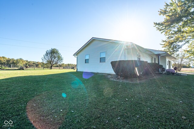 view of side of property featuring a yard