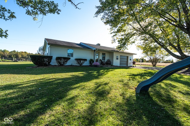 view of front of home featuring a garage and a front lawn