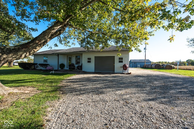 single story home with a garage and a front lawn