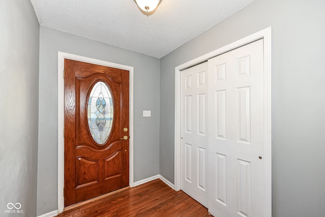 foyer featuring hardwood / wood-style flooring and a textured ceiling