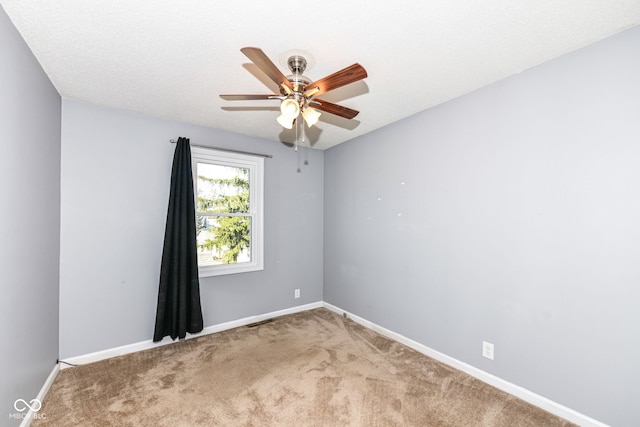 unfurnished room with ceiling fan, a textured ceiling, and carpet floors