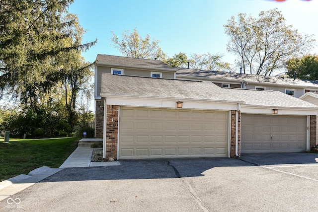 garage featuring a lawn